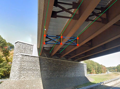 A steel girder bridge with cross-frame members connecting the girder